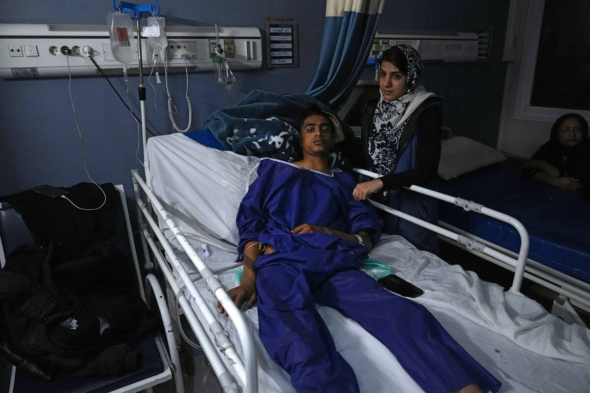 Mohammad Mehdi Ghalekhani, left, a member of Basij paramilitary force, who was wounded in Wedne ...