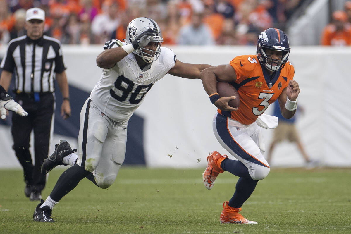 Raiders defensive tackle Jerry Tillery (90) pursues Denver Broncos quarterback Russell Wilson ( ...