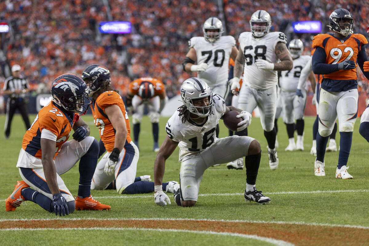 Raiders wide receiver Jakobi Meyers (16) scores a touchdown as Denver Broncos cornerback Damarr ...