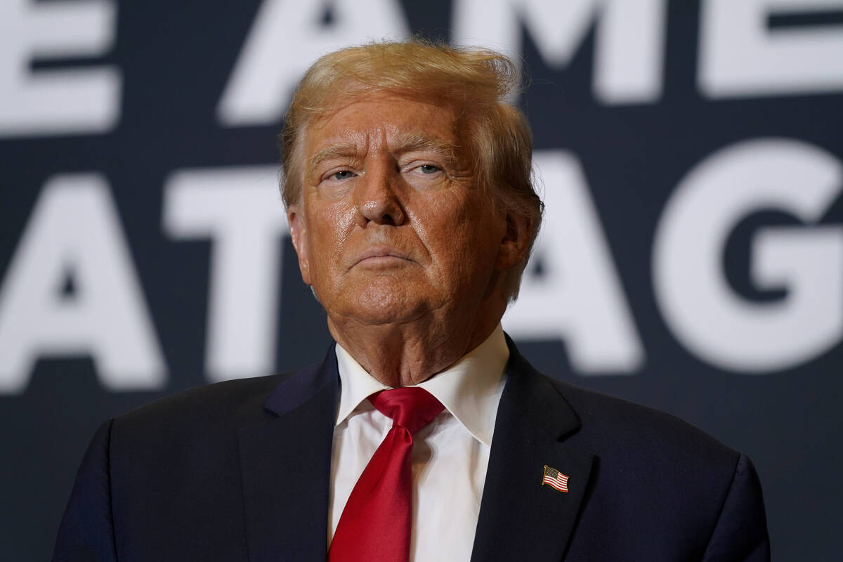 FILE - Former President Donald Trump arrives at a commit to caucus rally in Cedar Rapids, Iowa. ...