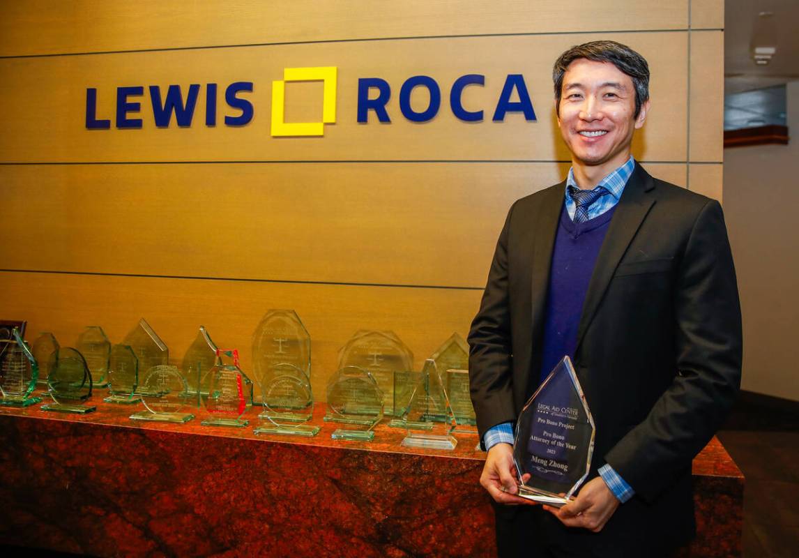 Meng Zhong, Pro Bono Attorney of the Year as selected by the Legal Aid Center, holds his honora ...