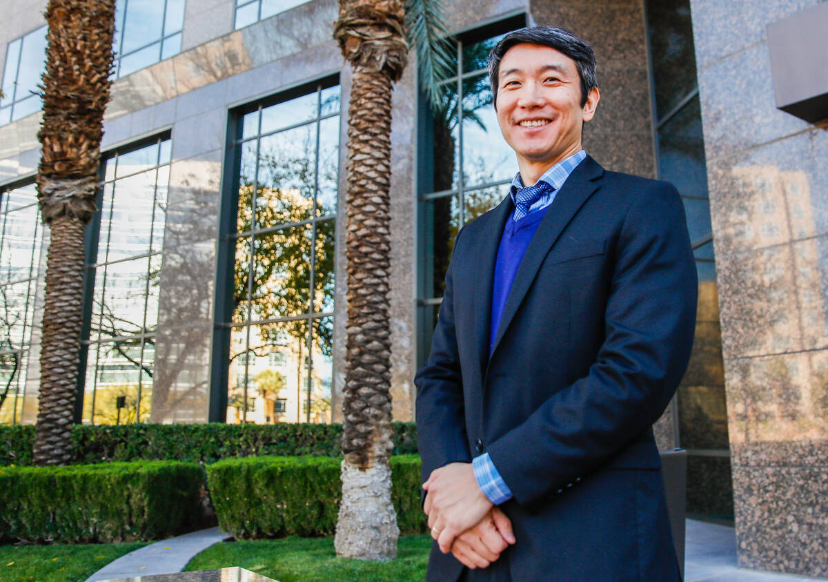 Meng Zhong, Pro Bono Attorney of the Year as honored by the Legal Aid Center, stands in front o ...