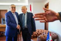 Lebanese Foreign Minister Abdallah Bouhabib, left, shakes hands with European Union foreign pol ...