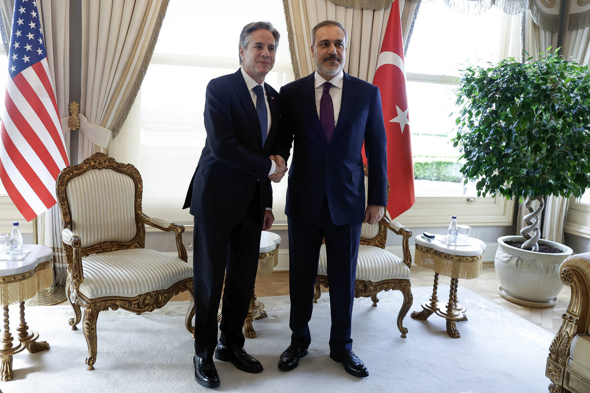 U.S. Secretary of State Antony Blinken, left, shakes hands with Turkish Foreign Minister Hakan ...