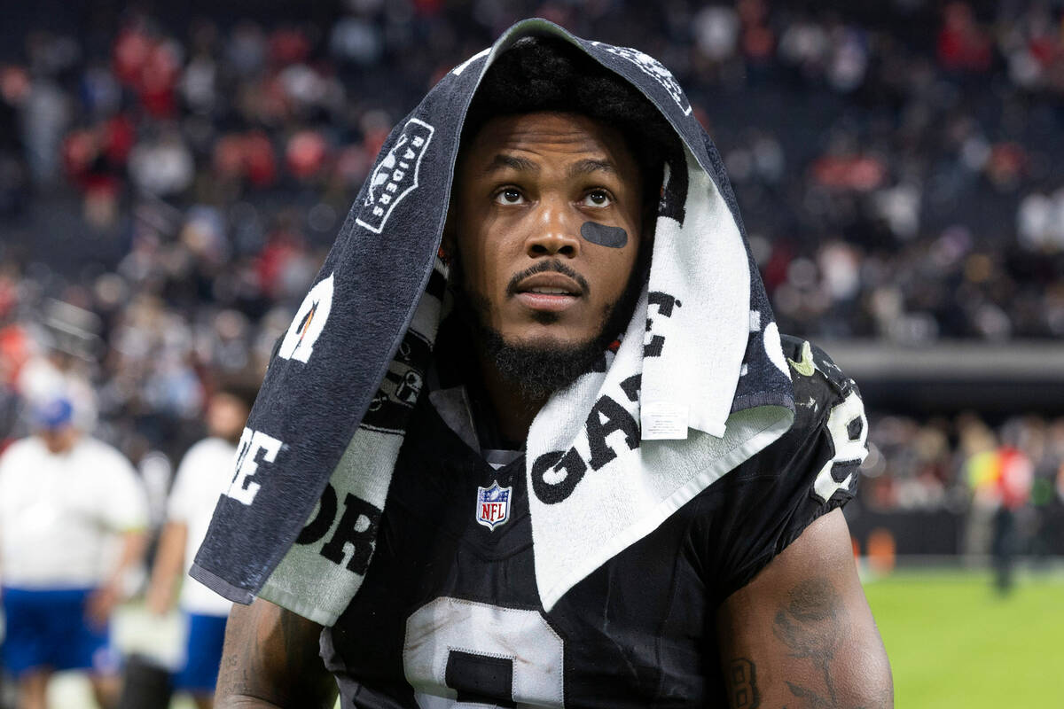 Raiders running back Josh Jacobs (8) looks to the fans while walking off the field after a loss ...