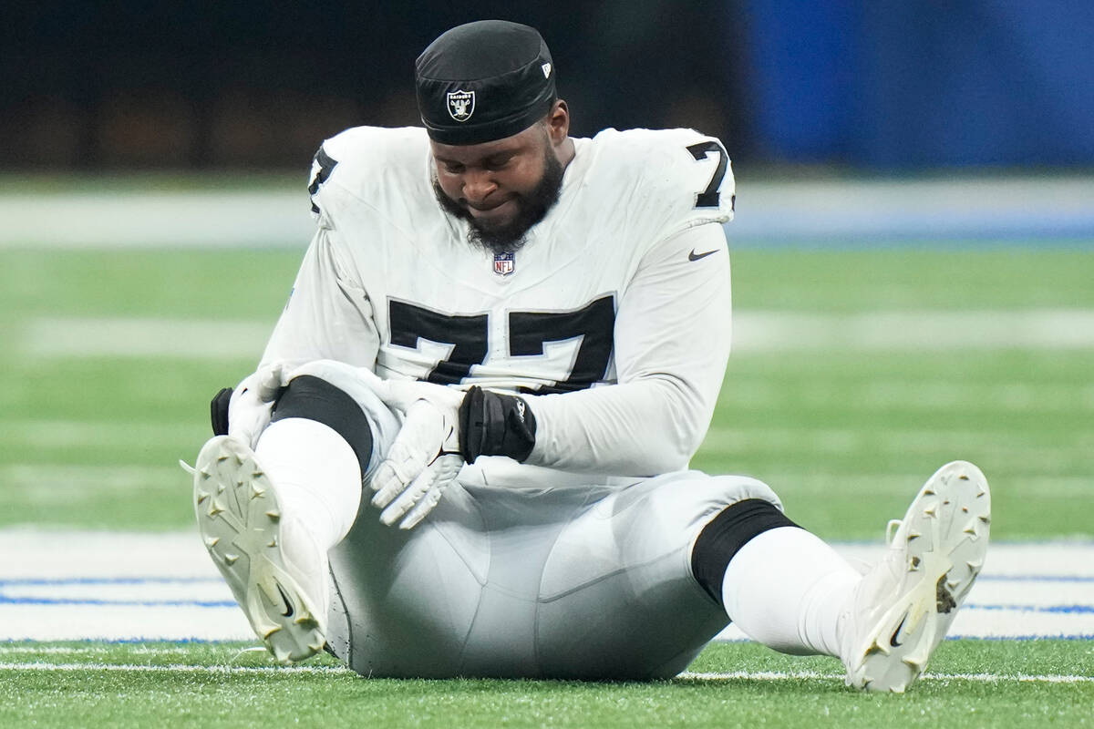 Las Vegas Raiders offensive tackle Thayer Munford Jr. (77) goes down with an injury during the ...