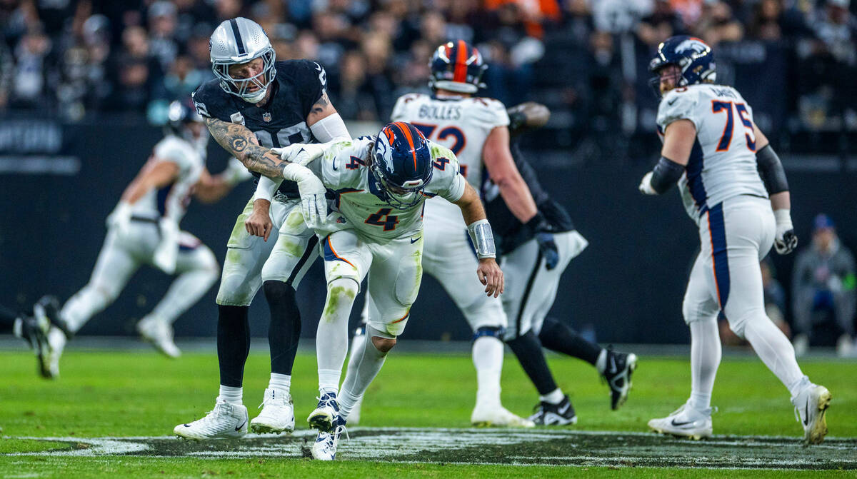 Raiders defensive end Maxx Crosby (98) gets another shot on Denver Broncos quarterback Jarrett ...