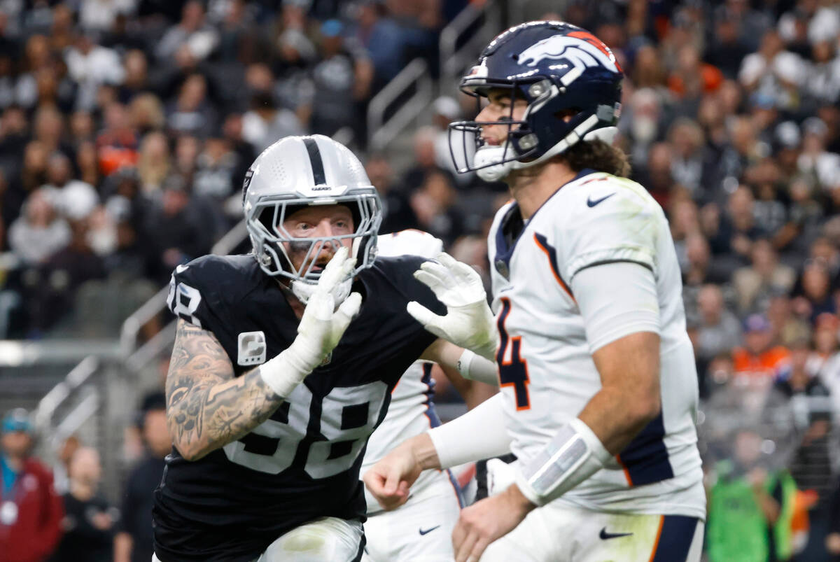 Denver Broncos quarterback Jarrett Stidham (4) throws the ball under pressure from Raiders defe ...