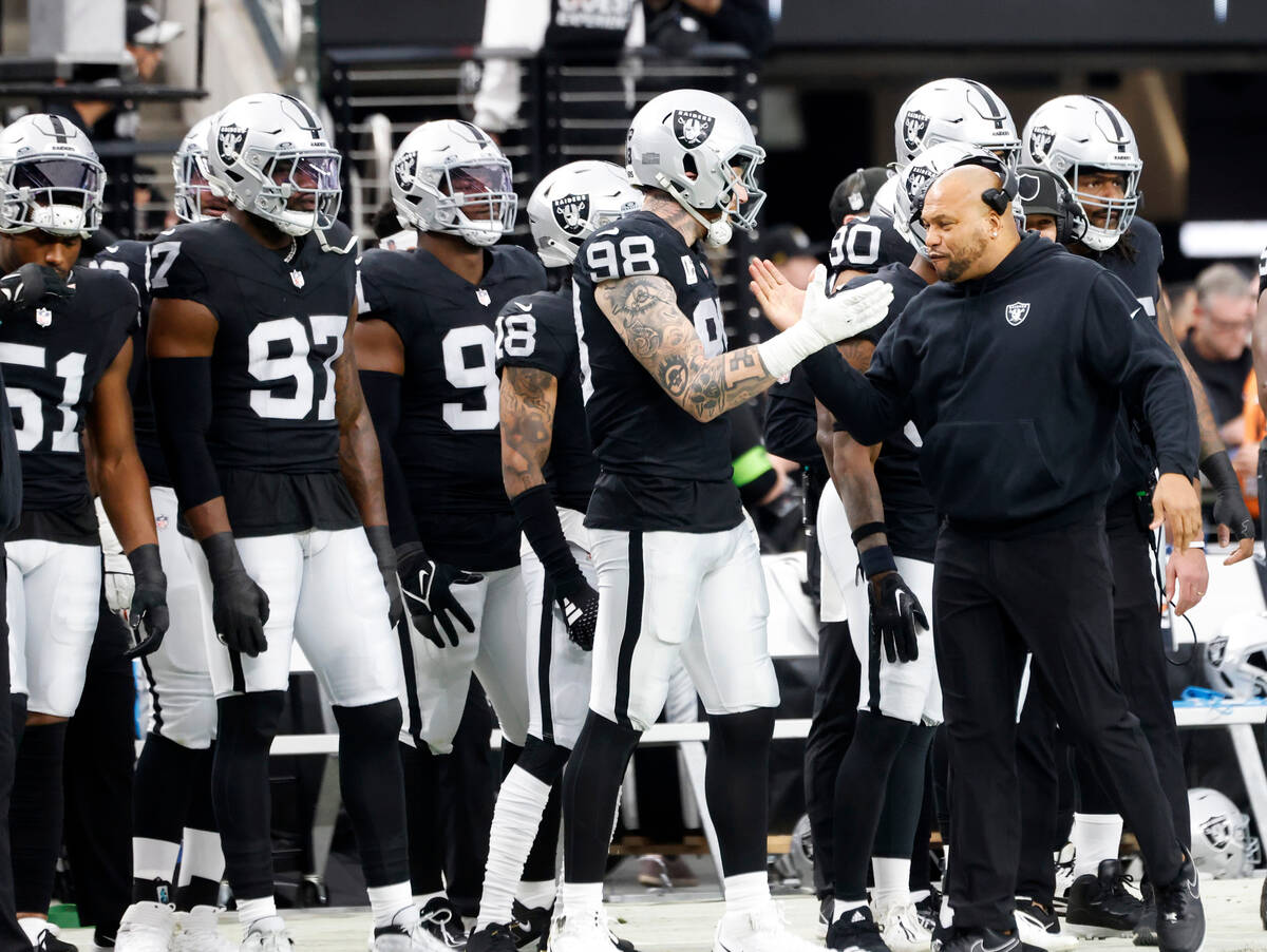 Raiders Interim Coach Antonio Pierce encourages his players on the sideline during the first ha ...