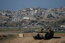 Israeli soldiers take up positions near the Gaza Strip border, in southern Israel, Sunday, Jan. ...