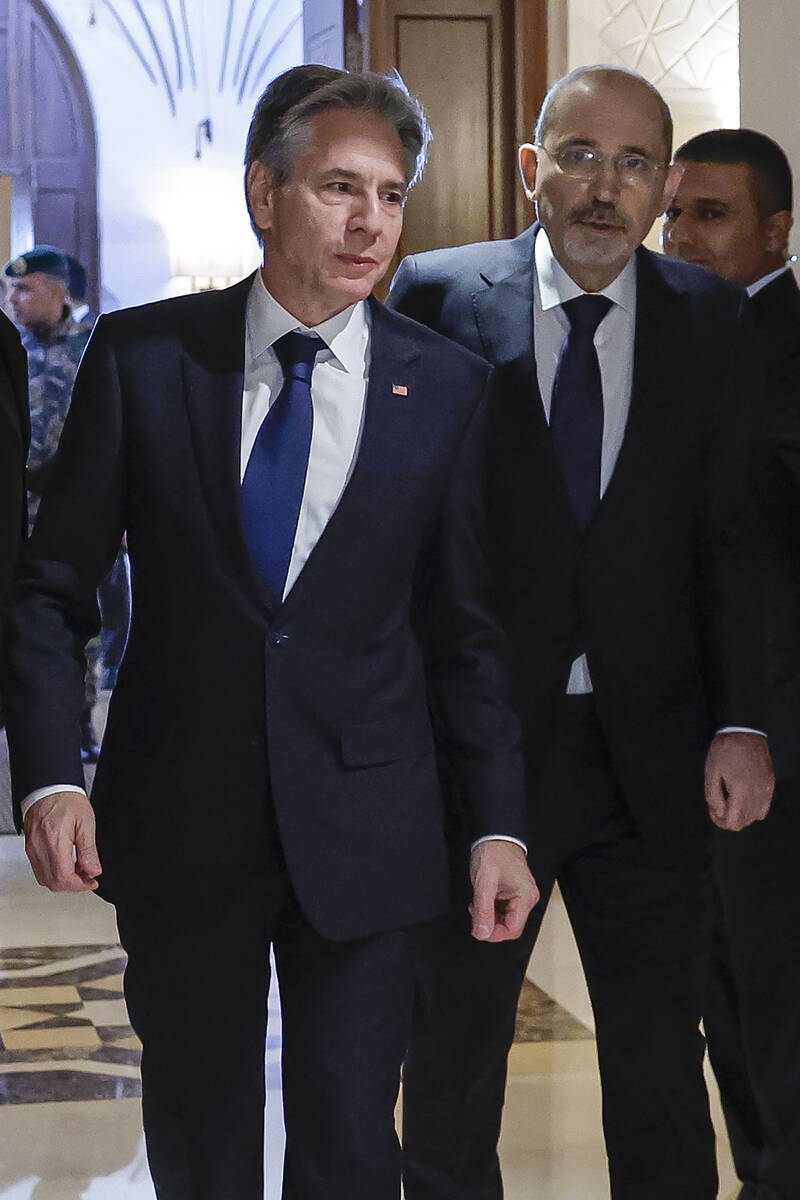 U.S. Secretary of State Antony Blinken, left, walks with Jordanian Foreign Minister Ayman Safad ...