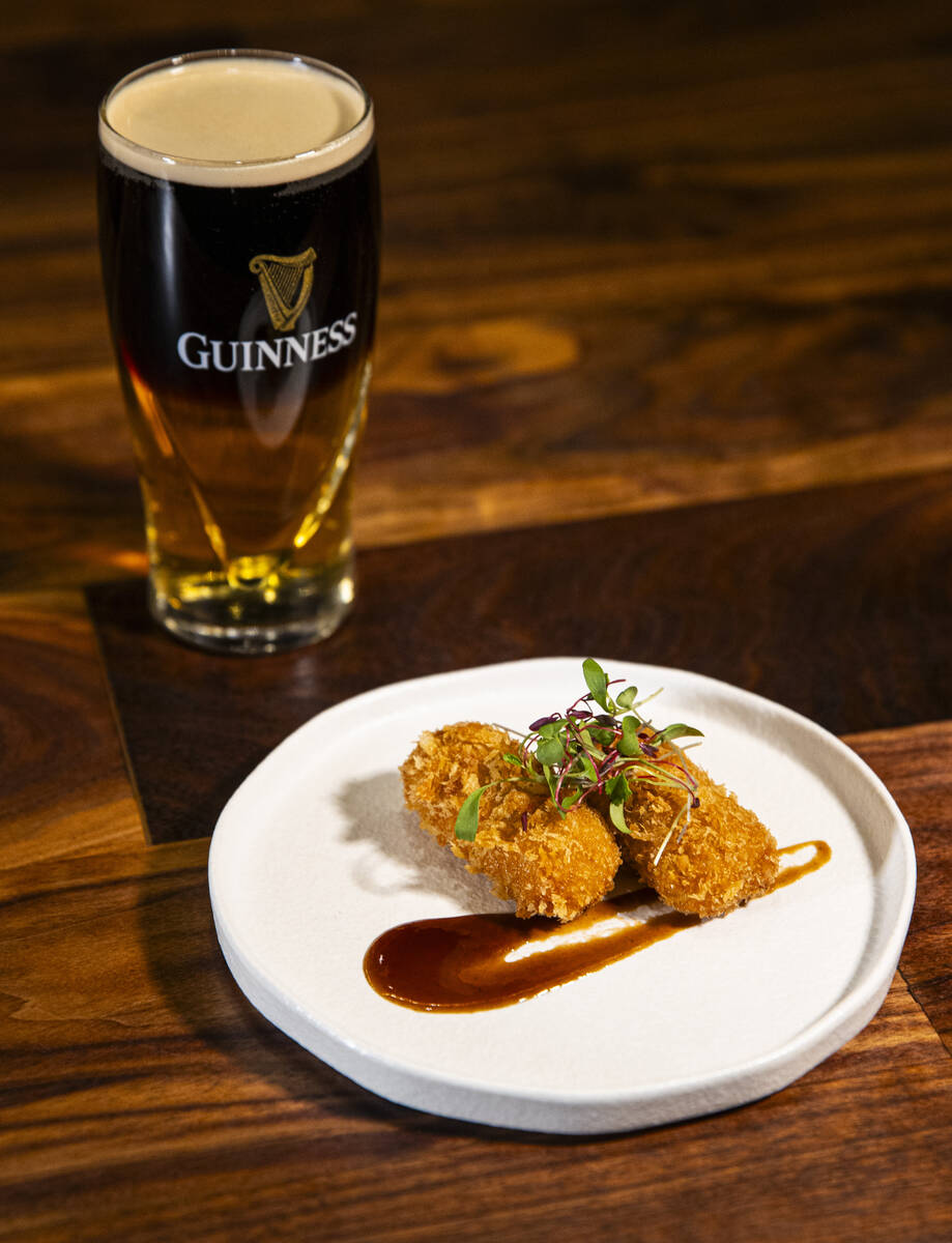 Croquetas de Jamon are pictured with a black & tan beer cocktail at Casa de Raku, a tapas b ...