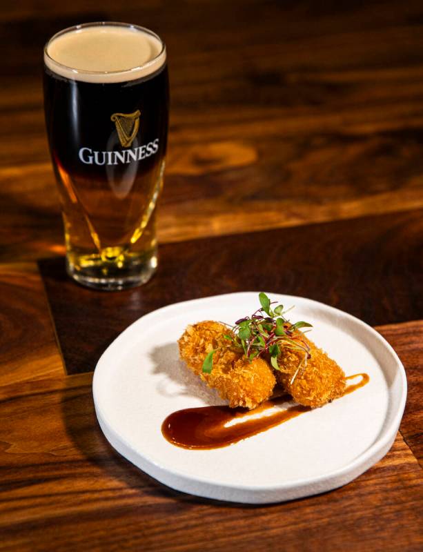 Croquetas de Jamon are pictured with a black & tan beer cocktail at Casa de Raku, a tapas b ...