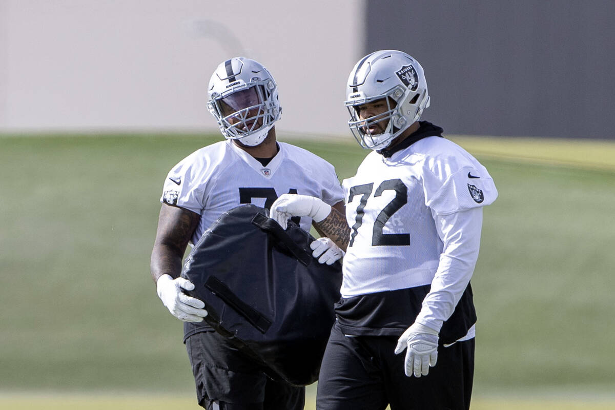 Raiders offensive linemen Justin Herron (71) and Jermaine Eluemunor (72) work on positional dri ...