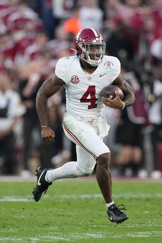 Alabama quarterback Jalen Milroe (4) carries against Michigan during the second half in the Ros ...