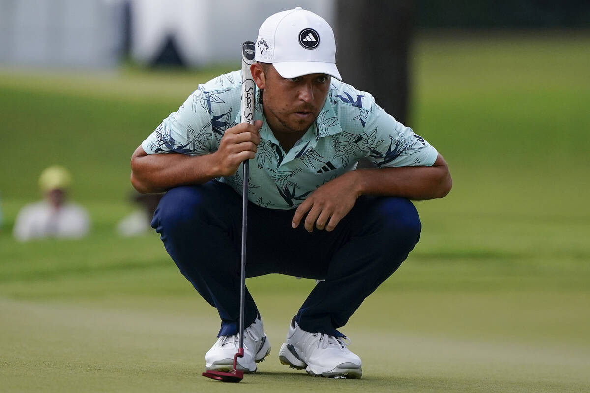 Xander Schauffele lines up a putt on the fifth green during the third round of the Tour Champio ...