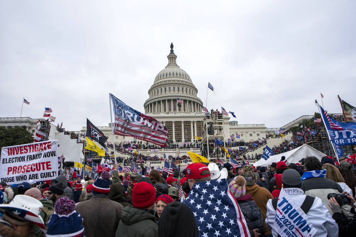 FILE - Rioters loyal to President Donald Trump gather on the West Front of the U.S. Capitol in ...