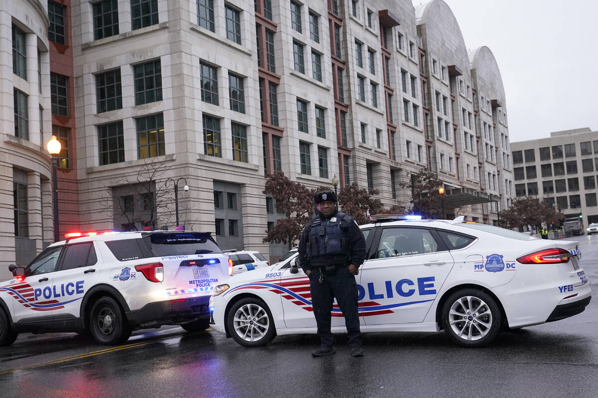 Police stand guard as they wait for former President Donald Trump to arrive at federal court ho ...