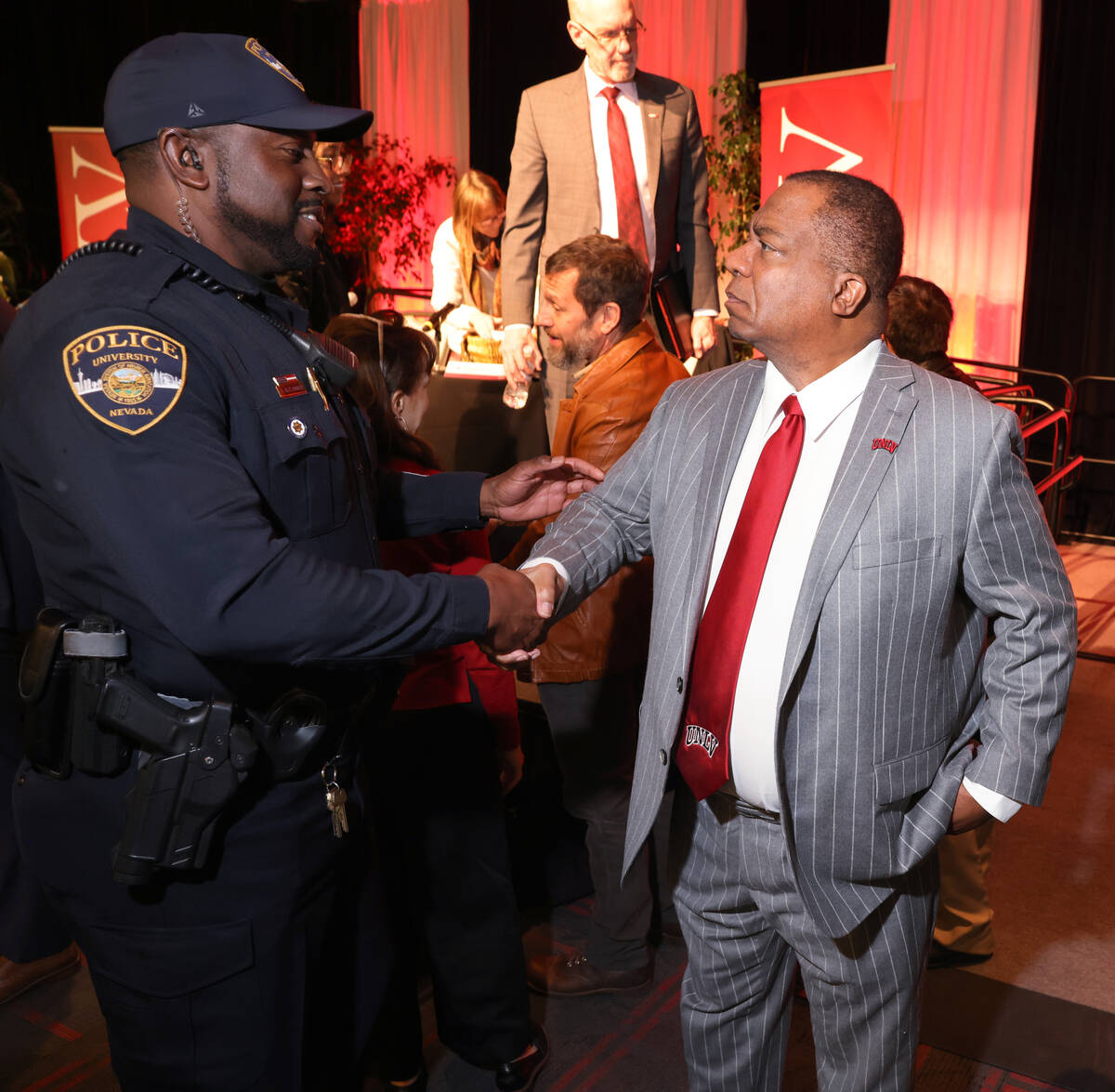 UNLV President Keith Whitfield, right, greets Lt. Roy Alexander with University Police Services ...