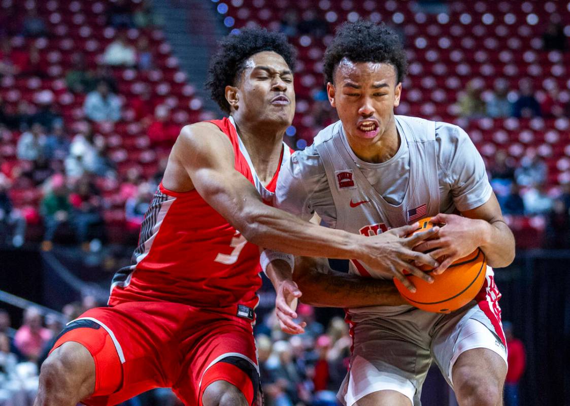 UNLV guard Dedan Thomas Jr. (11) is fouled on the drive by New Mexico Lobos guard Tru Washingto ...