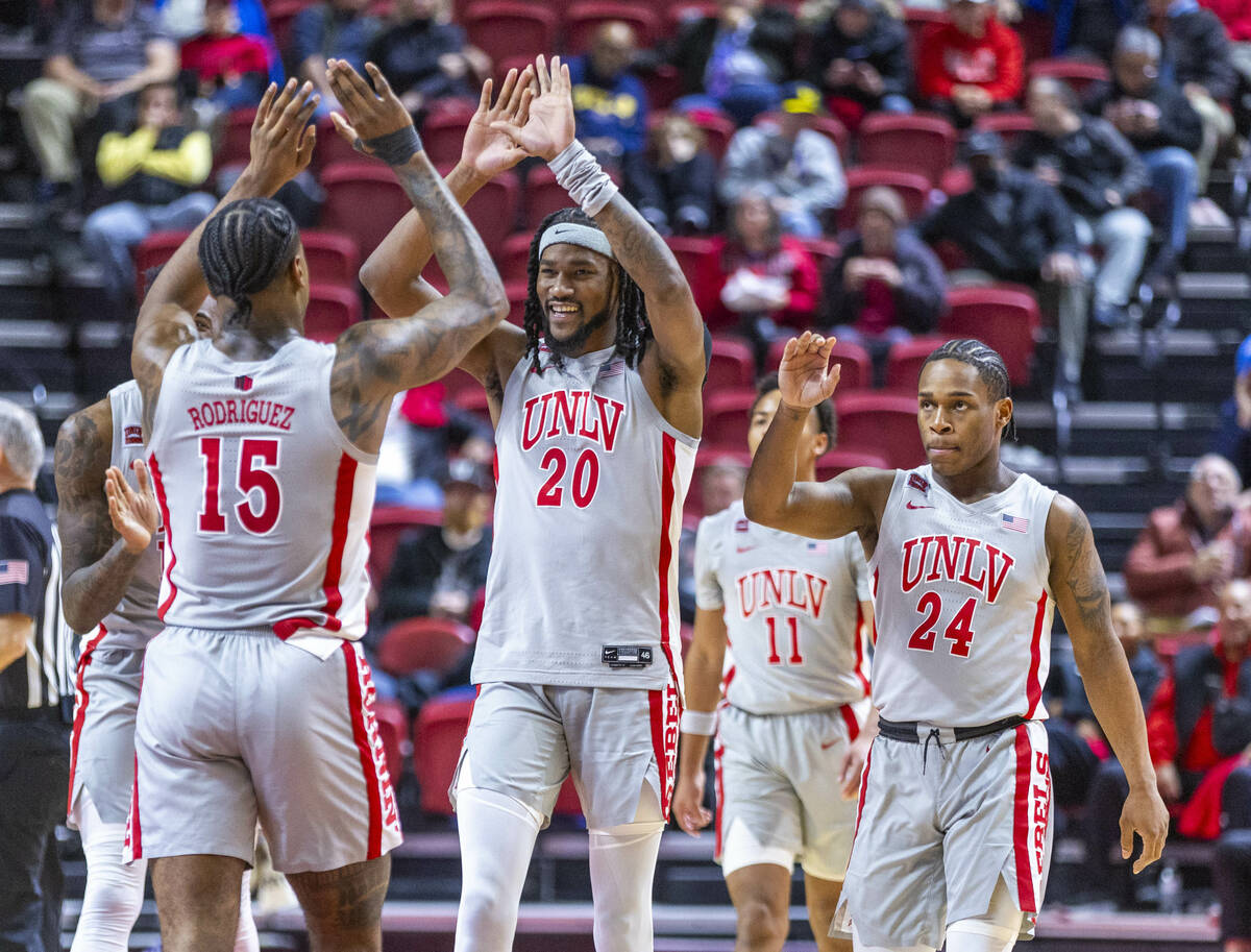 UNLV forward Keylan Boone (20) and teammates are congratulated on their lead by guard Luis Rodr ...