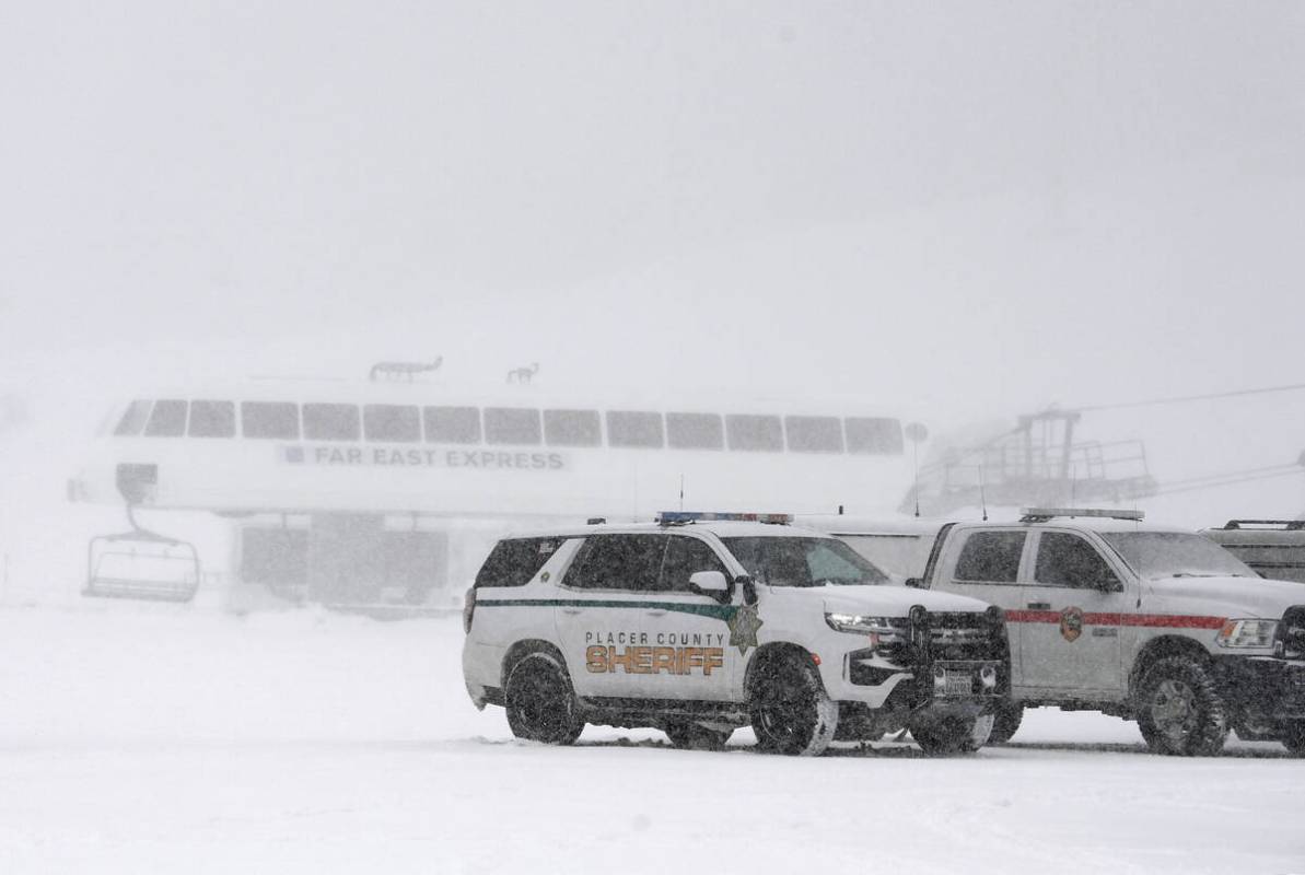 Placer County sheriff vehicles are parked near the ski lift at Palisades Tahoe where avalanche ...
