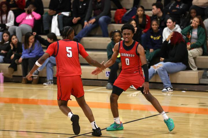 Coronado guard Jonny Collins (0) and Coronado's Lantz Stephenson (5) slap hands after scoring d ...