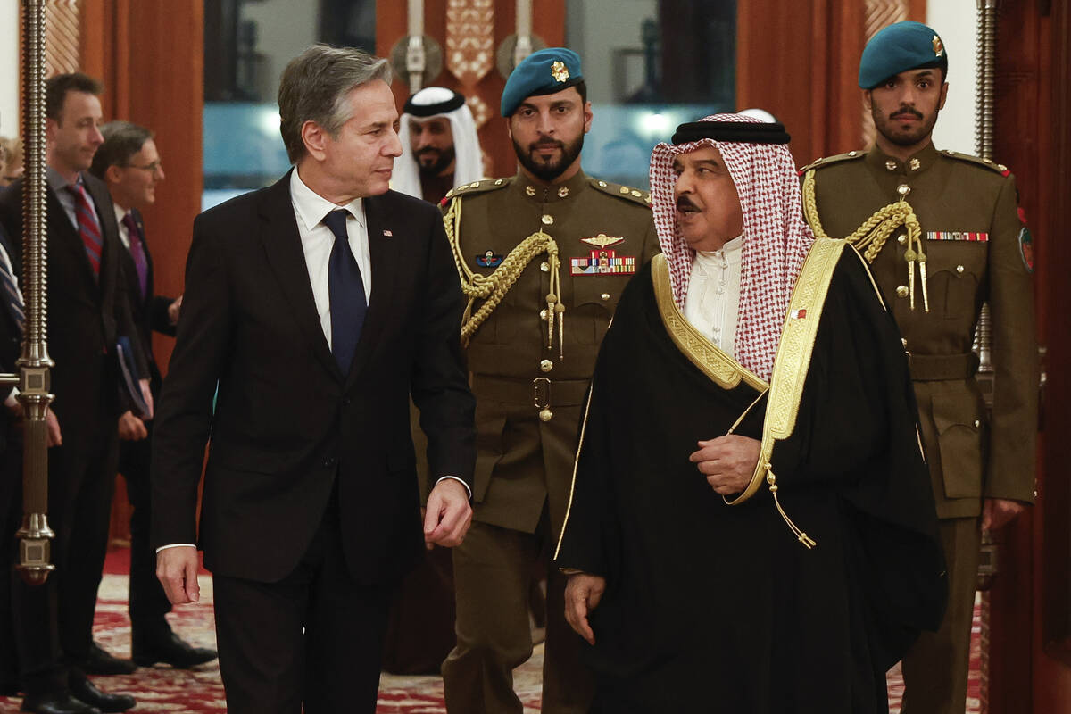 U.S. Secretary of State Antony Blinken, left, walks with Bahrain's King Hamad bin Isa al-Khalif ...