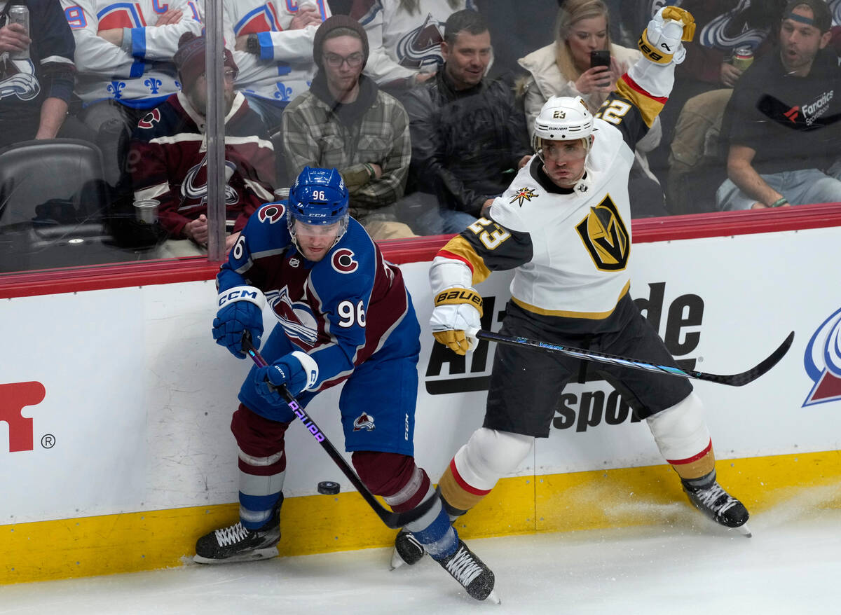 Colorado Avalanche right wing Mikko Rantanen, left, swings at the puck next to Vegas Golden Kni ...