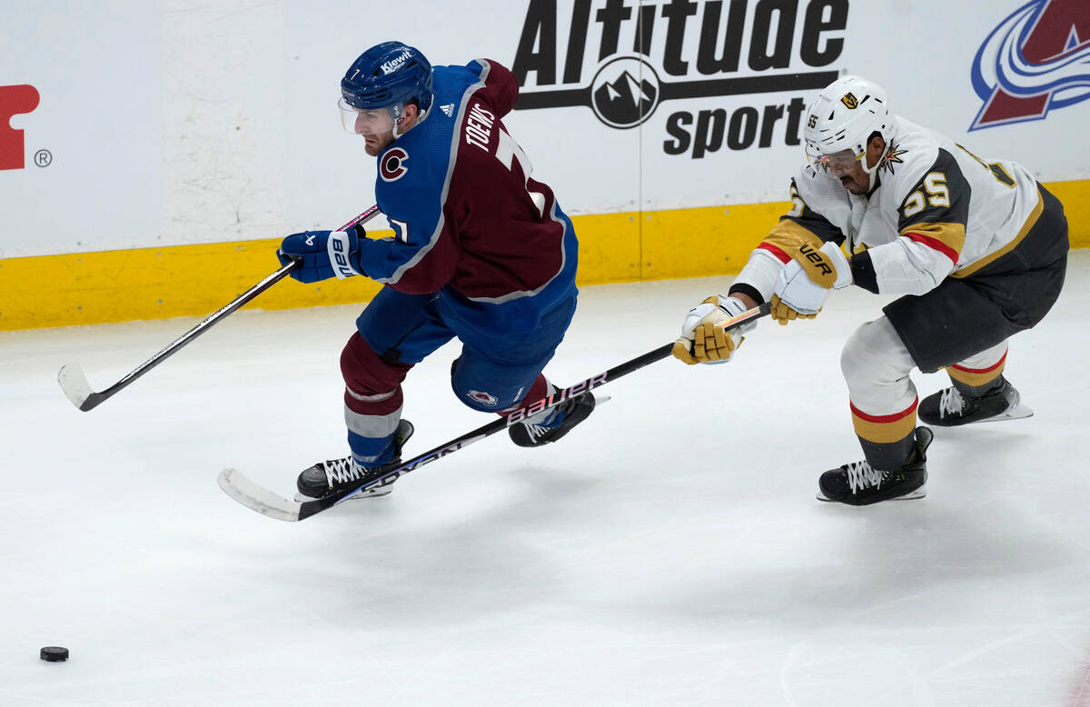 Colorado Avalanche defenseman Devon Toews, left, drives past Vegas Golden Knights right wing Ke ...