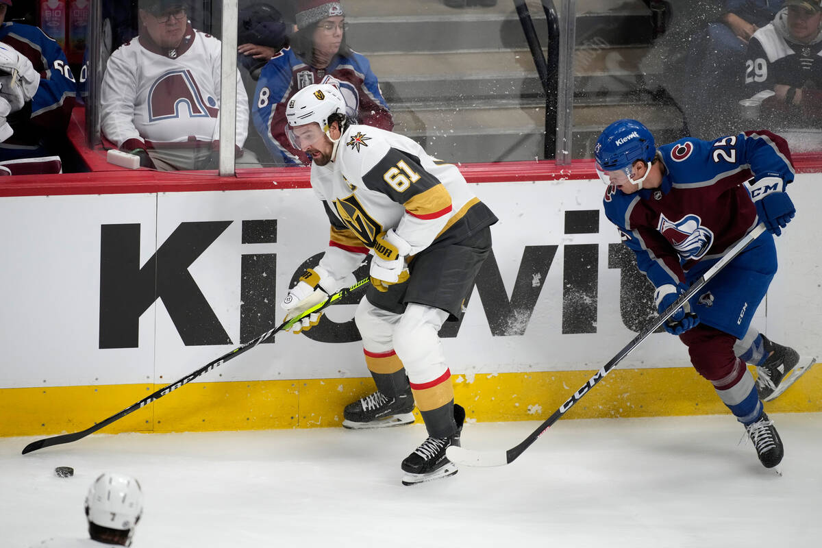 Vegas Golden Knights right wing Mark Stone, left, looks to pass the puck as Colorado Avalanche ...