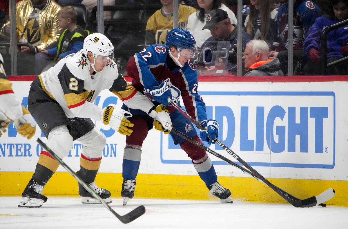 Colorado Avalanche left wing Fredrik Olofsson, right, reaches for the puck next to Vegas Golden ...