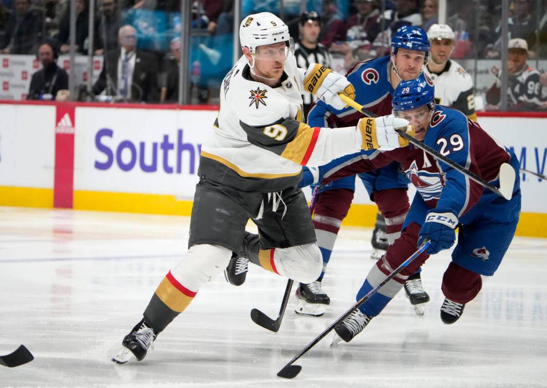 Vegas Golden Knights center Jack Eichel, left, shoots the puck as Colorado Avalanche center Nat ...