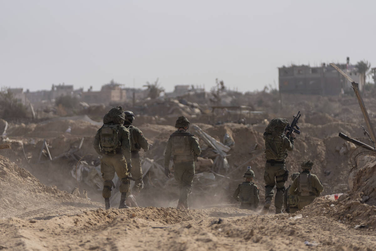 Israeli soldiers take up positions during a ground operation in Khan Younis, Gaza Strip on Wedn ...