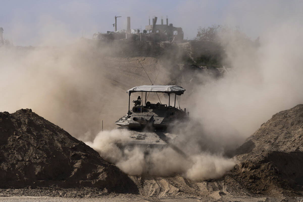 Israeli army tank moves during a ground operation in Khan Younis, Gaza Strip on Wednesday, Jan. ...