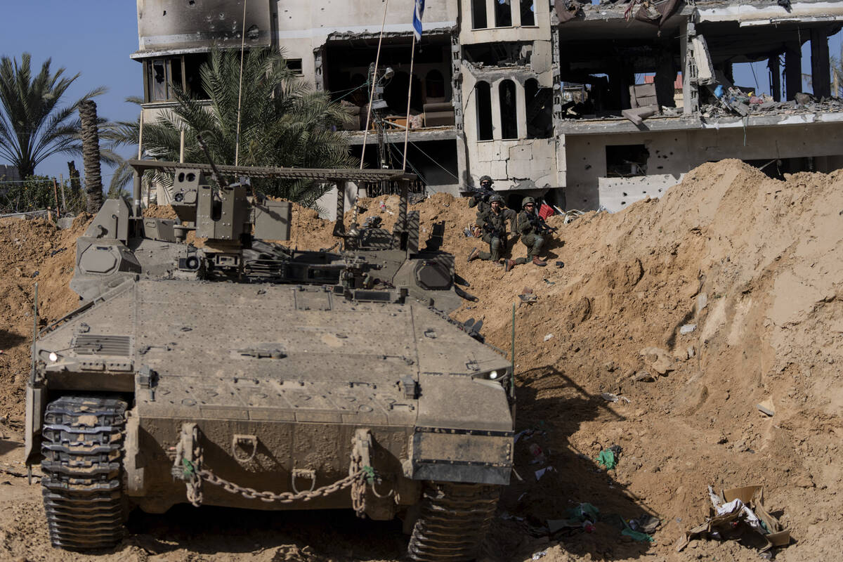 Israeli soldiers take up positions during a ground operation in Khan Younis, Gaza Strip on Wedn ...