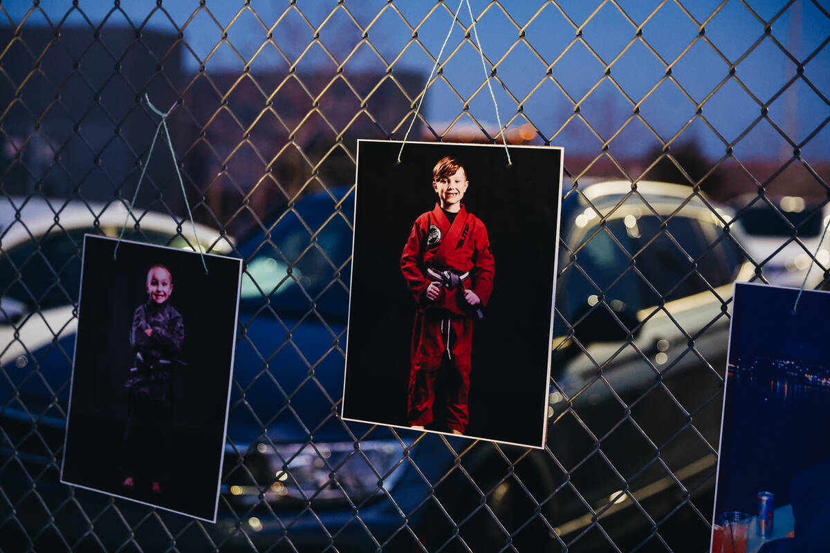 Photographs of Achilles Quintanilla and Leo Post-Quintanilla are attached to a fence during a v ...