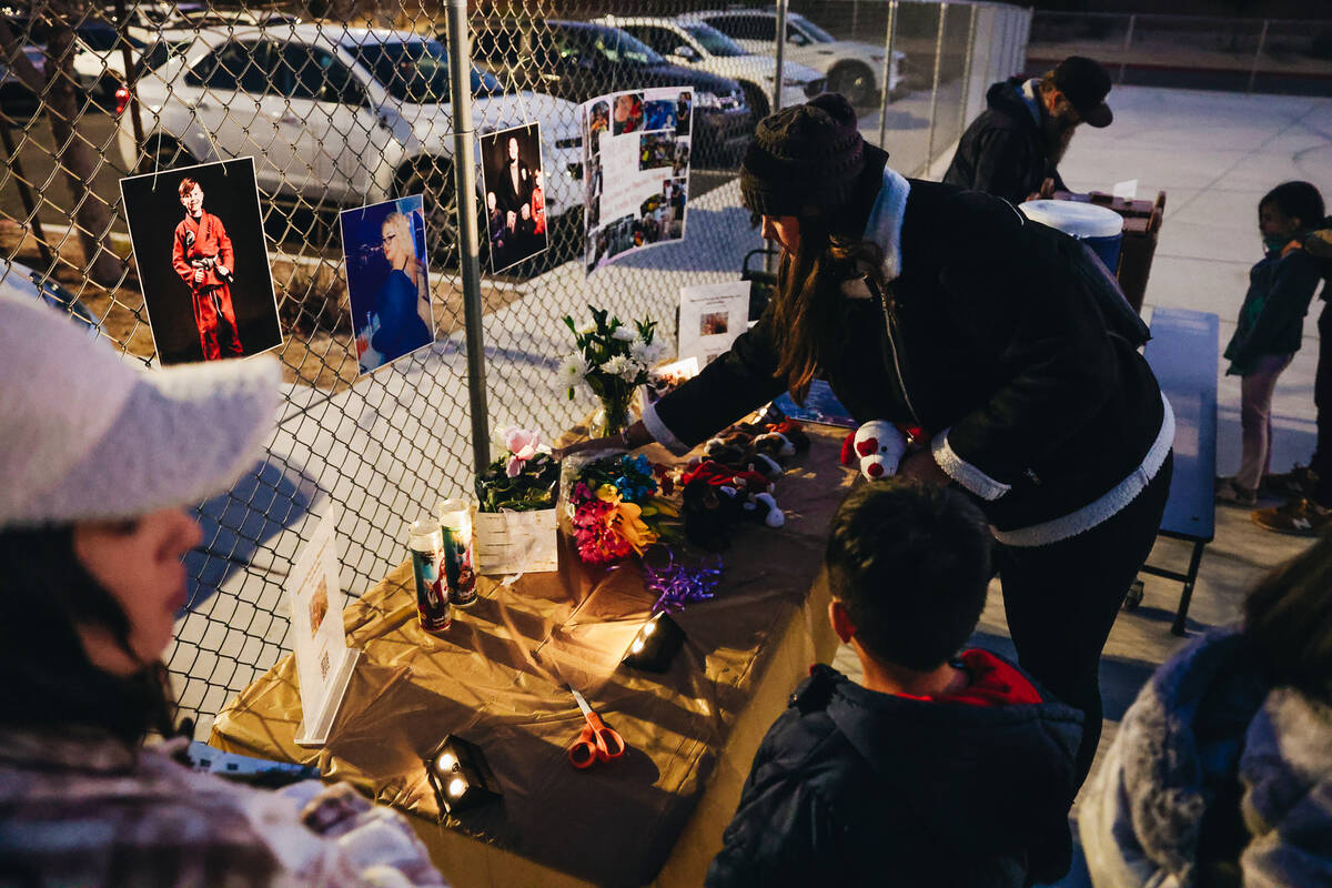 Flowers are laid at a table during a vigil for Rebecca Post, Achilles Quintanilla and Leo Post- ...