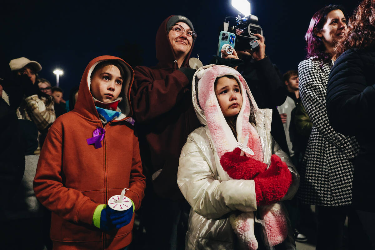 Mourners get emotional as Leighonna Post, out of frame, talks about the loss of her brothers an ...