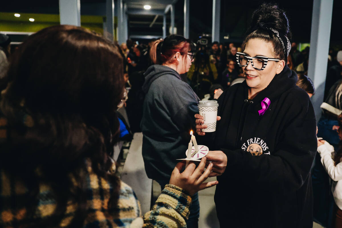 Mourners light candles during a vigil for Rebecca Post, Achilles Quintanilla and Leo Post-Quint ...