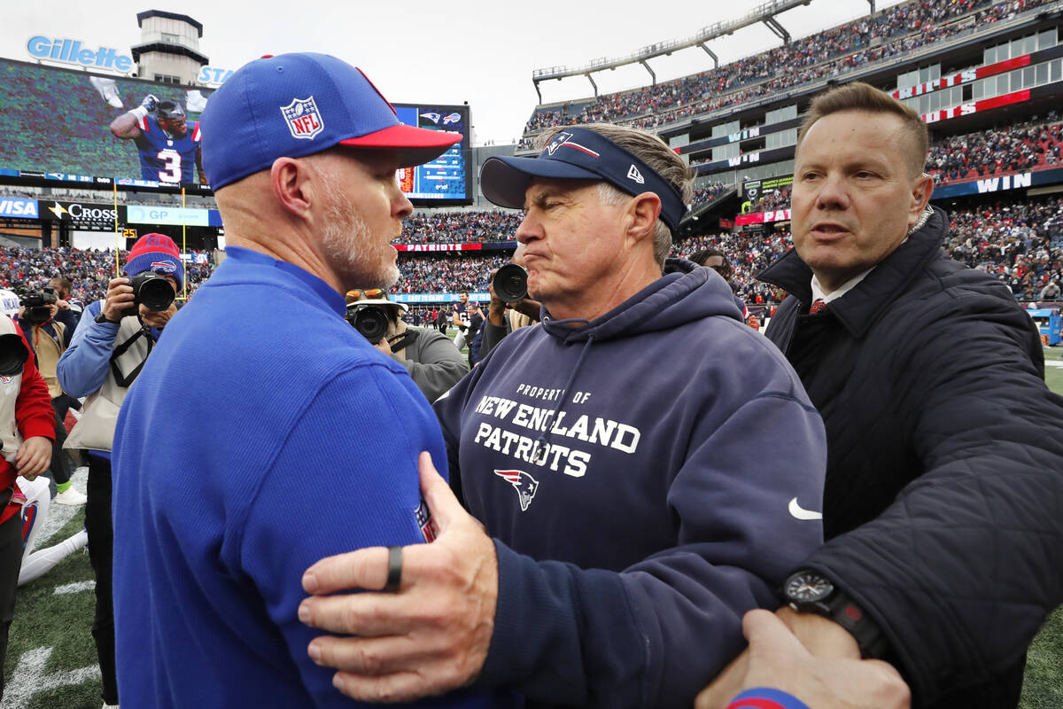 New England Patriots head coach Bill Belichick, right, embraces Buffalo Bills head coach Sean M ...