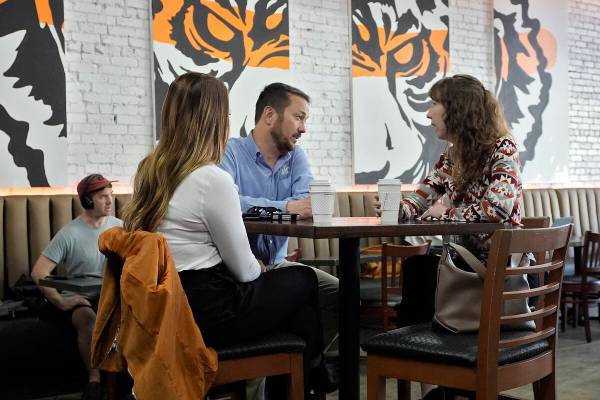 Customers drink coffee at the Blind Tiger Cafe Wednesday, Jan. 10, 2024, in Tampa, Fla. (AP Pho ...