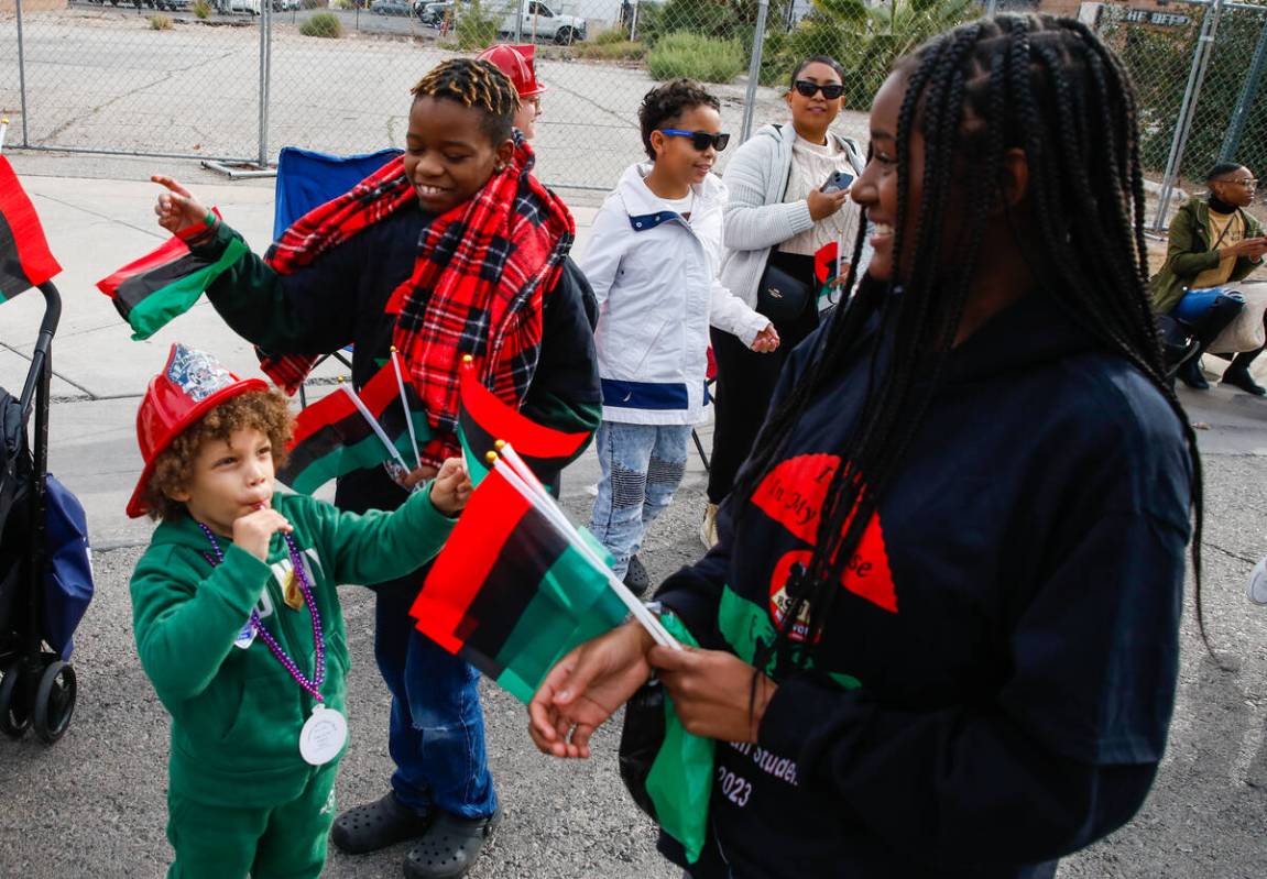 Members of the Black Student Union Network hand out flags during the annual Martin Luther King ...