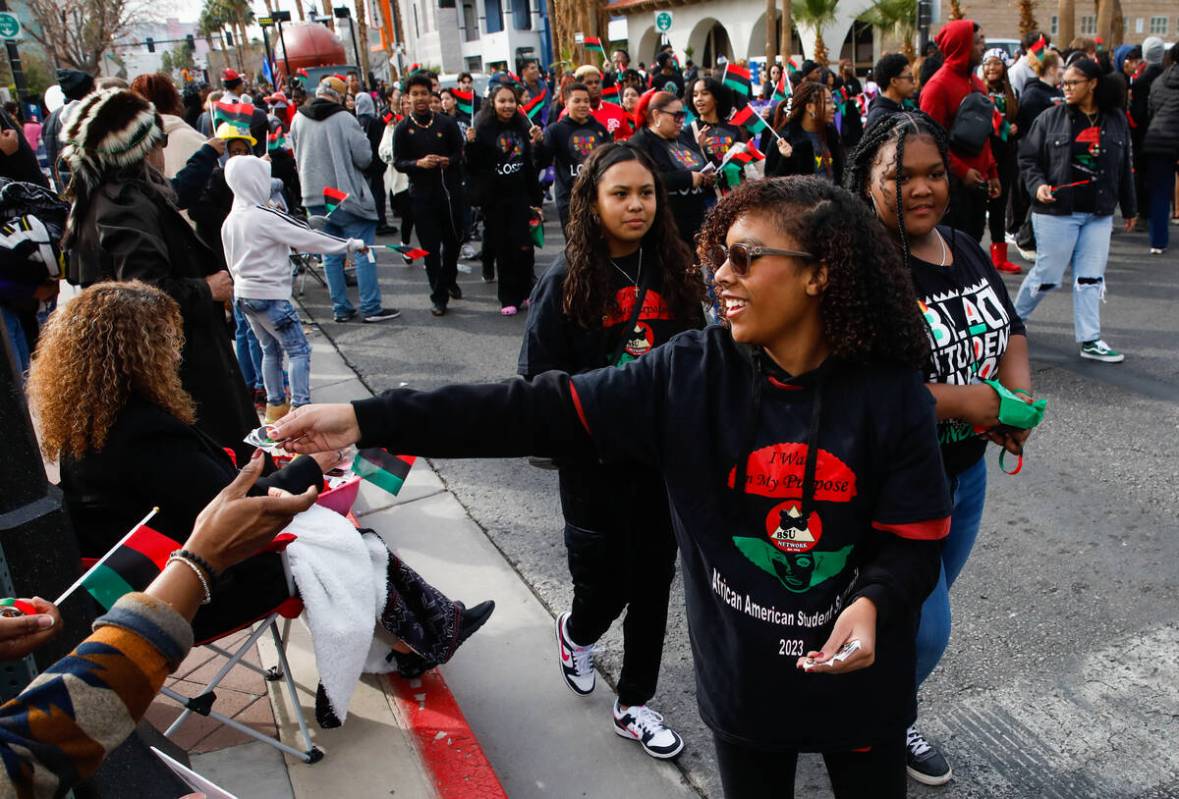 Members of the Black Student Union Network hand out flags during the annual Martin Luther King ...