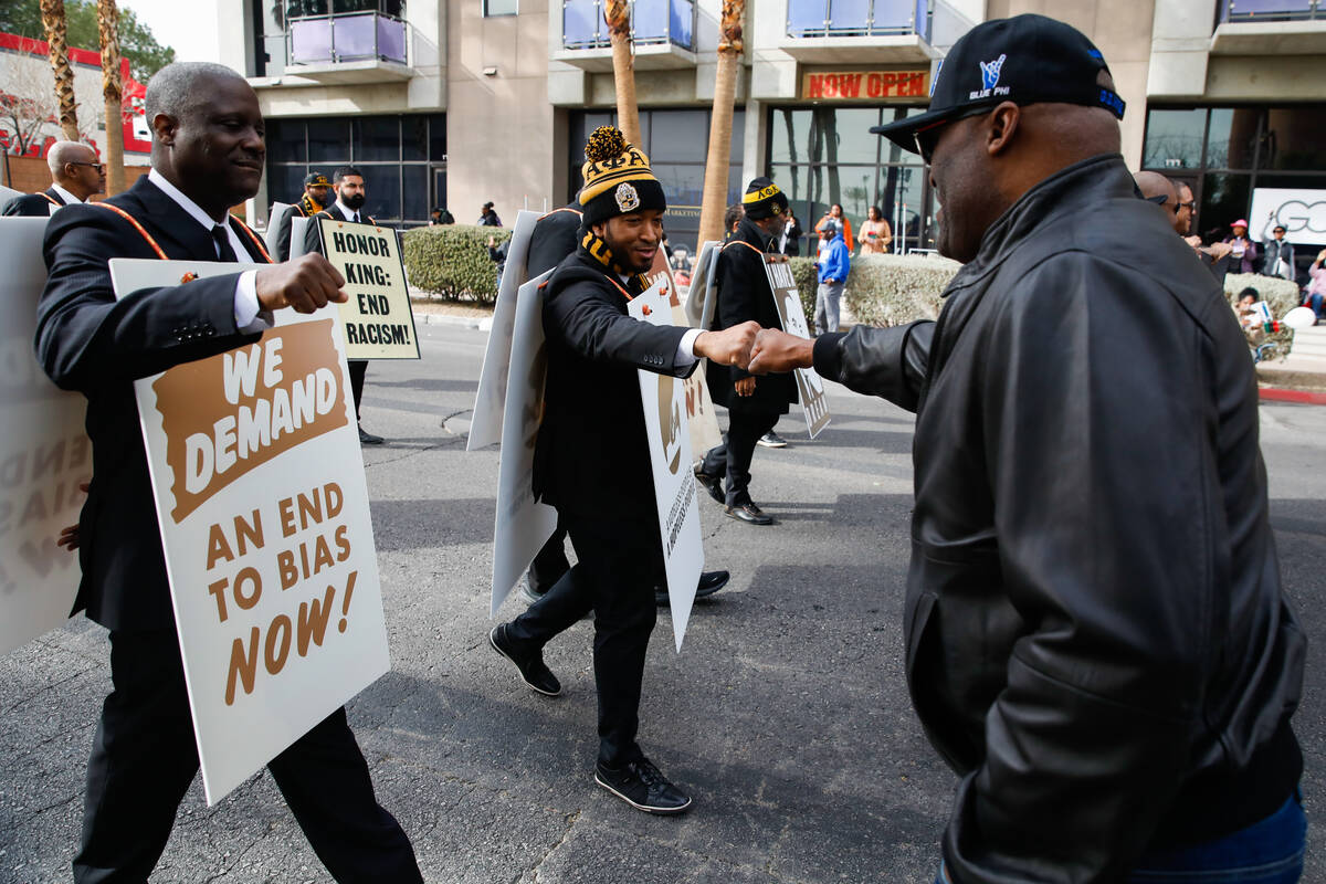 Albert Cole greets members of Theta Pi Lambda fraternity during the annual Martin Luther King J ...