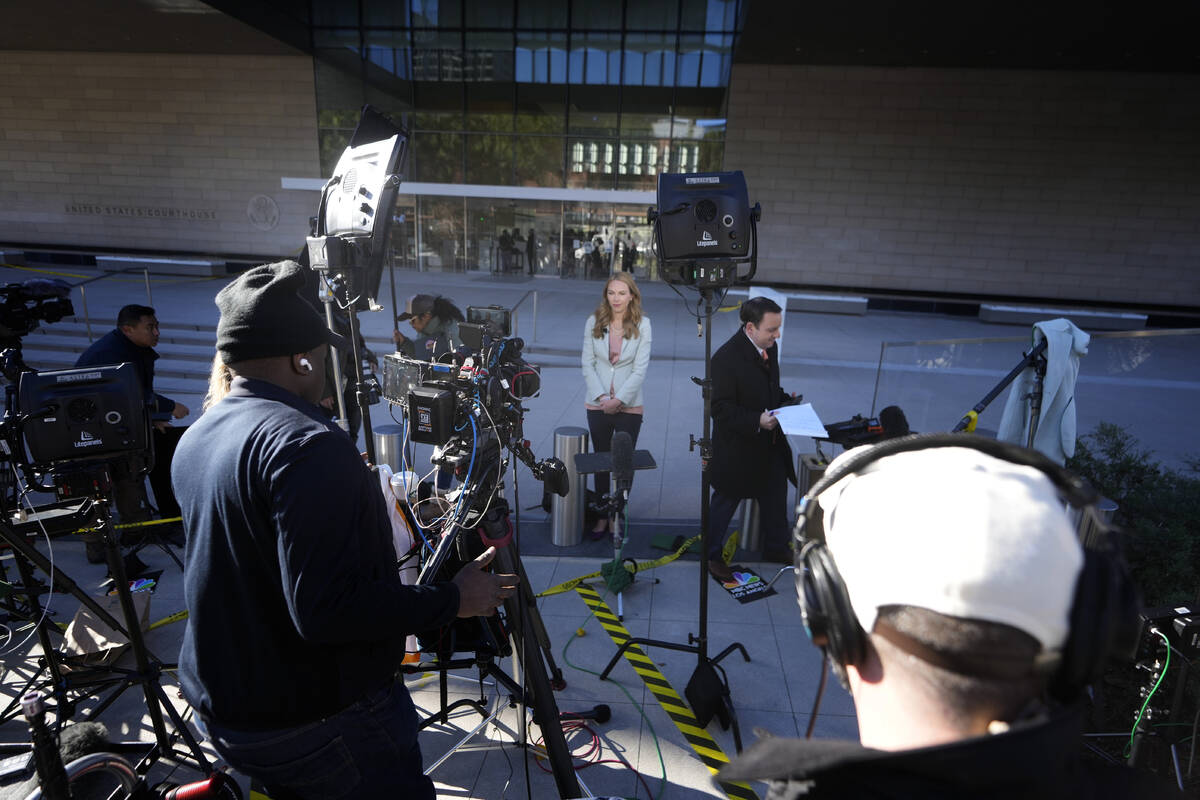 News crews wait in front of a federal courthouse Thursday, Jan. 11, 2024, in Los Angeles. Hunte ...