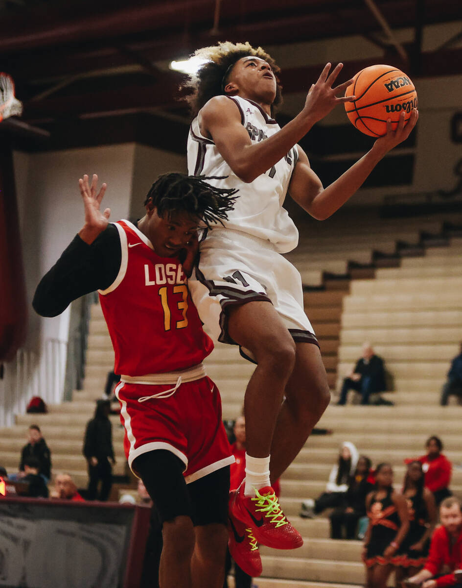 Cimarron-Memorial small forward Geremiah Rone (11) goes up for a basket as Somerset-Losee guard ...