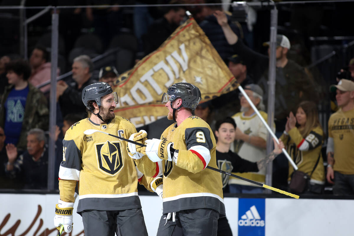 Golden Knights right wing Mark Stone (61) and Golden Knights center Jack Eichel (9) celebrate a ...