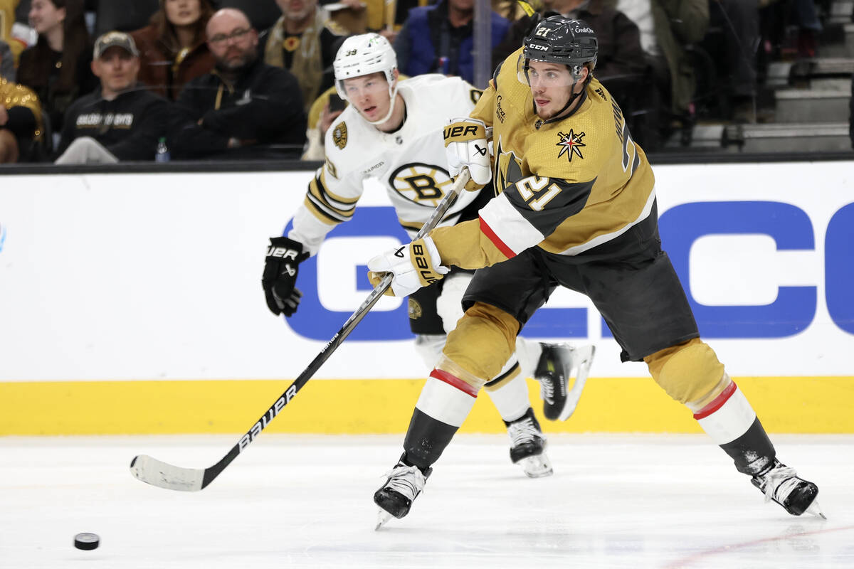 Golden Knights center Brett Howden (21) passes up the ice while Bruins center Morgan Geekie (39 ...