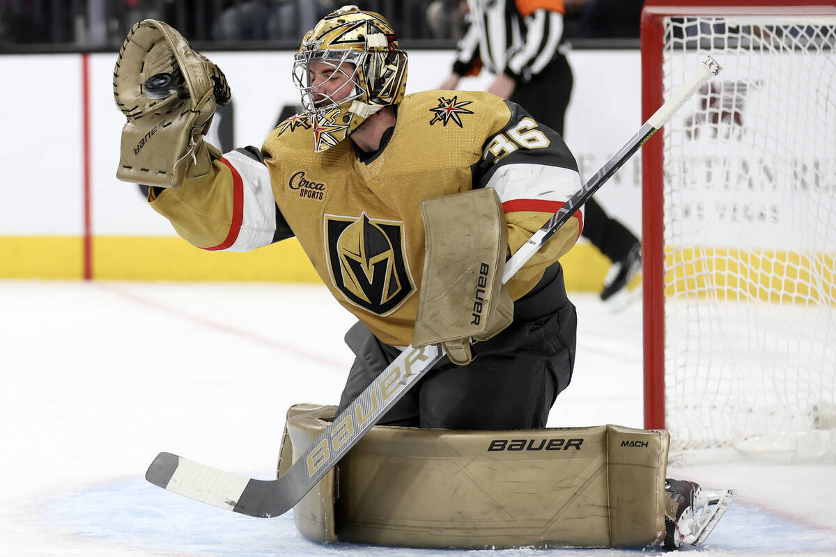 Golden Knights goaltender Logan Thompson (36) makes a glove save during the second period of an ...